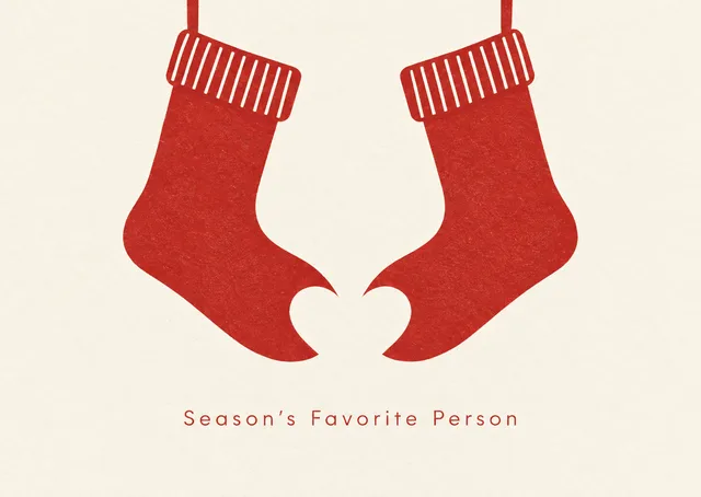 A warm, playful Christmas card for anyone on your mailing list, with two stockings whose gap forms a heart. Clever and cheerful, it suits friends and family alike.